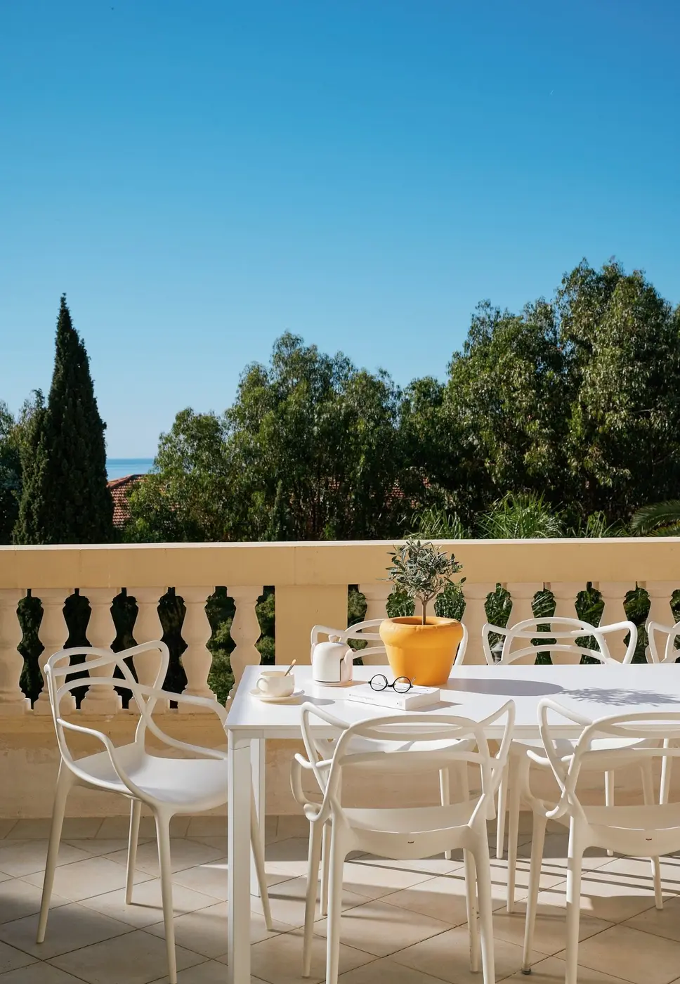 Table set on the south-facing terrace overlooking the sea
